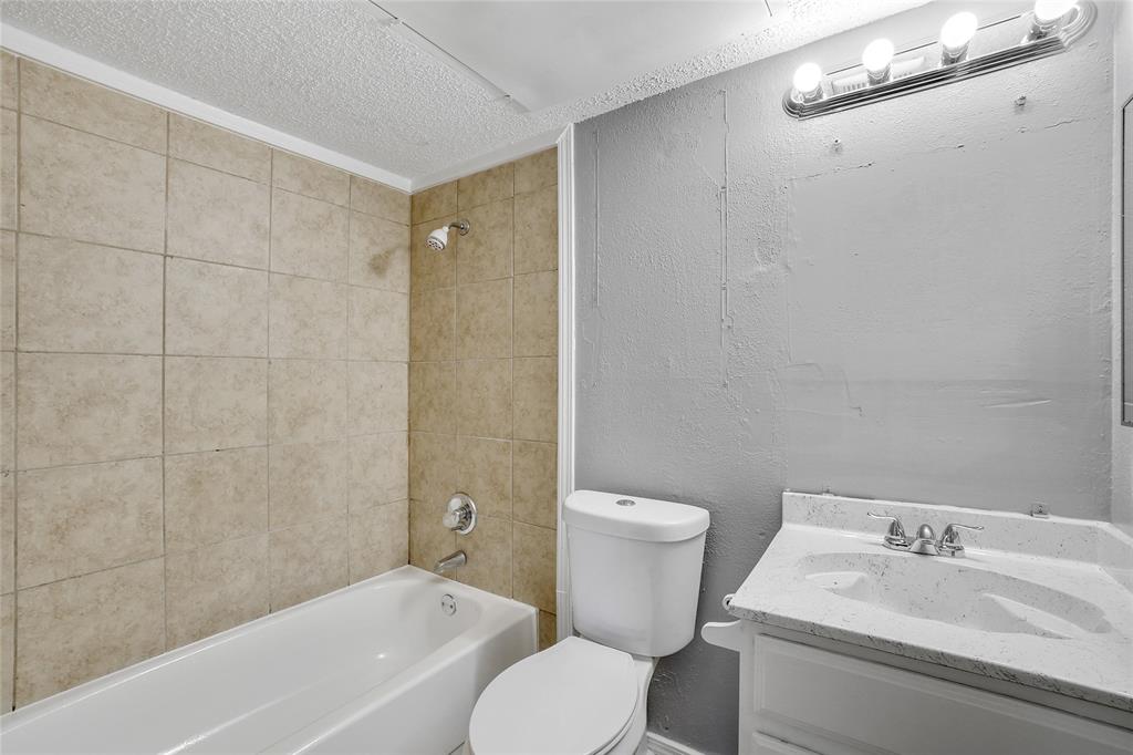 9815 Walnut Street, Unit 214 Dallas, TX 75243 - Photo 18 of 29 a bathroom with a sink toilet and shower