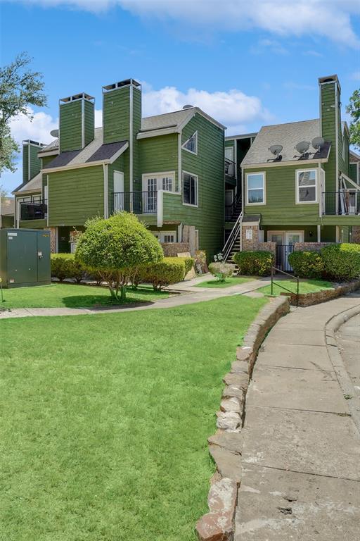 9815 Walnut Street, Unit 214 Dallas, TX 75243 - Photo 2 of 29 a front view of a house with a yard and potted plants