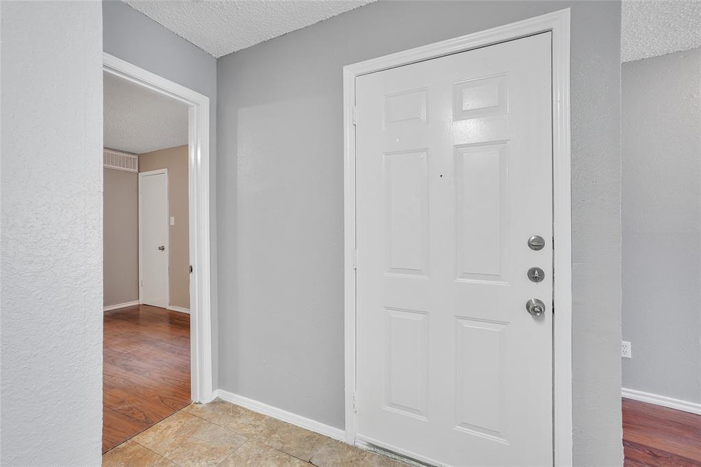9815 Walnut Street, Unit 214 Dallas, TX 75243 - Photo 9 of 29 a view of a hallway with wooden floor