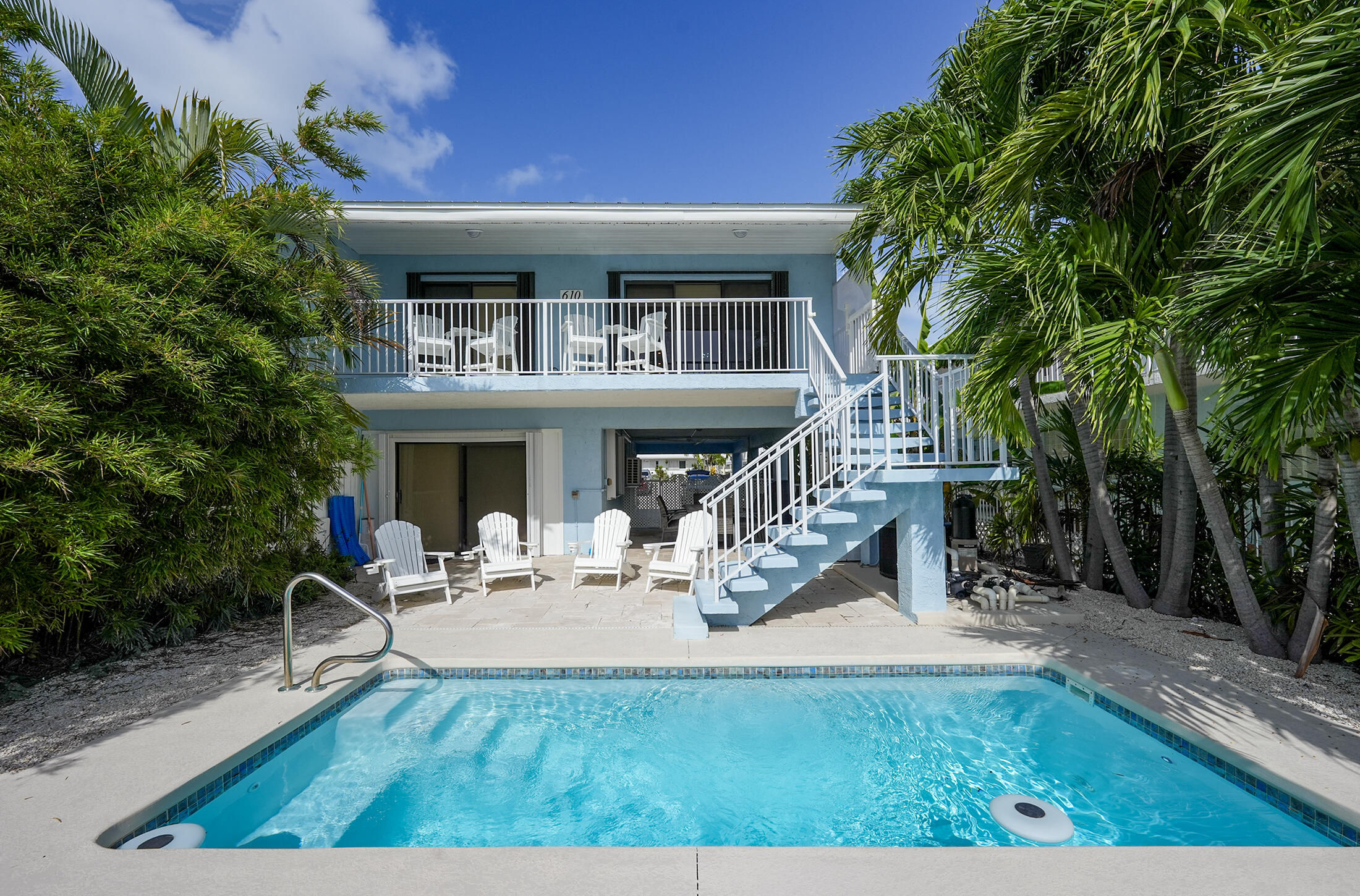 a view of a house with backyard porch and sitting area