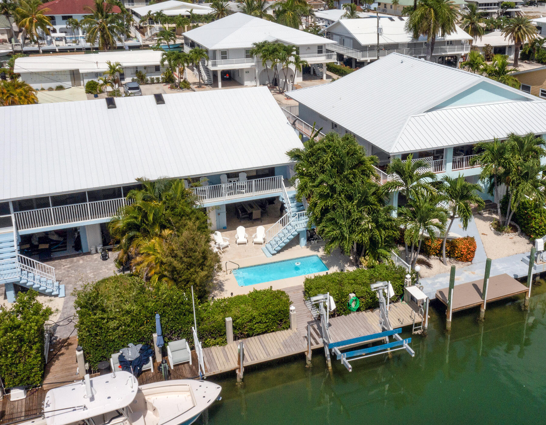 610 9th Street Key Colony Beach, FL 33051 - Photo 3 of 28 a view of a patio with table and chairs potted plants