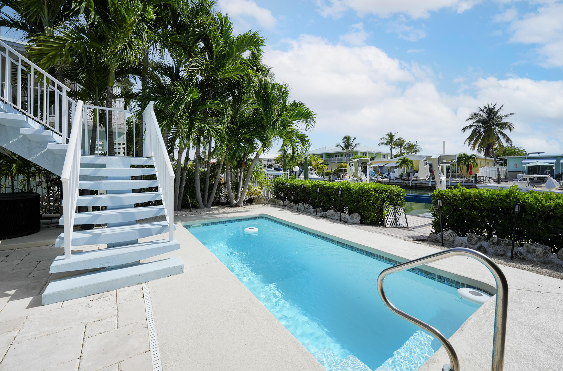610 9th Street Key Colony Beach, FL 33051 - Photo 4 of 28 a view of a swimming pool with a garden and plants