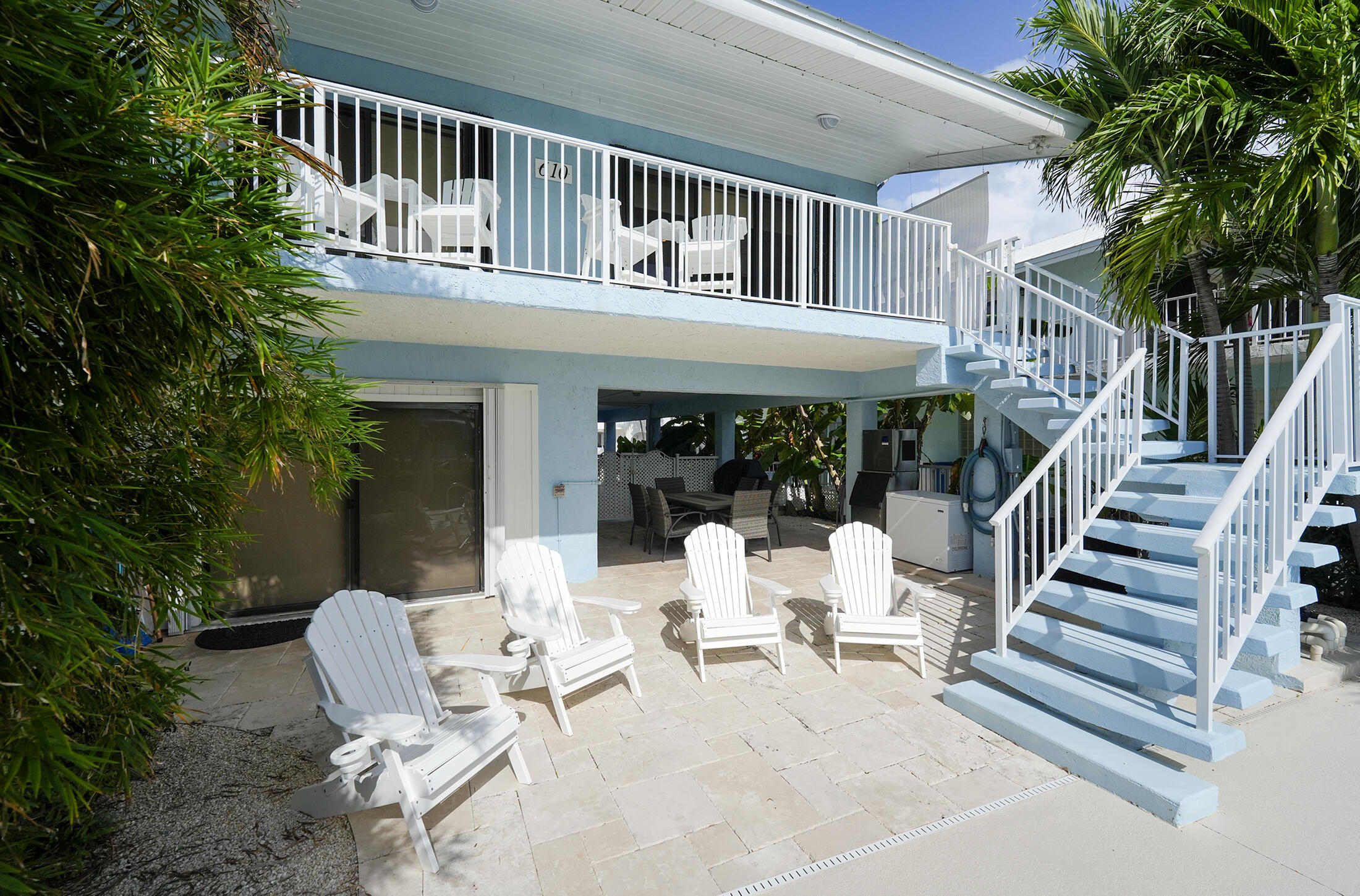 610 9th Street Key Colony Beach, FL 33051 - Photo 7 of 28 a view of a patio with couches table and chairs and potted plants