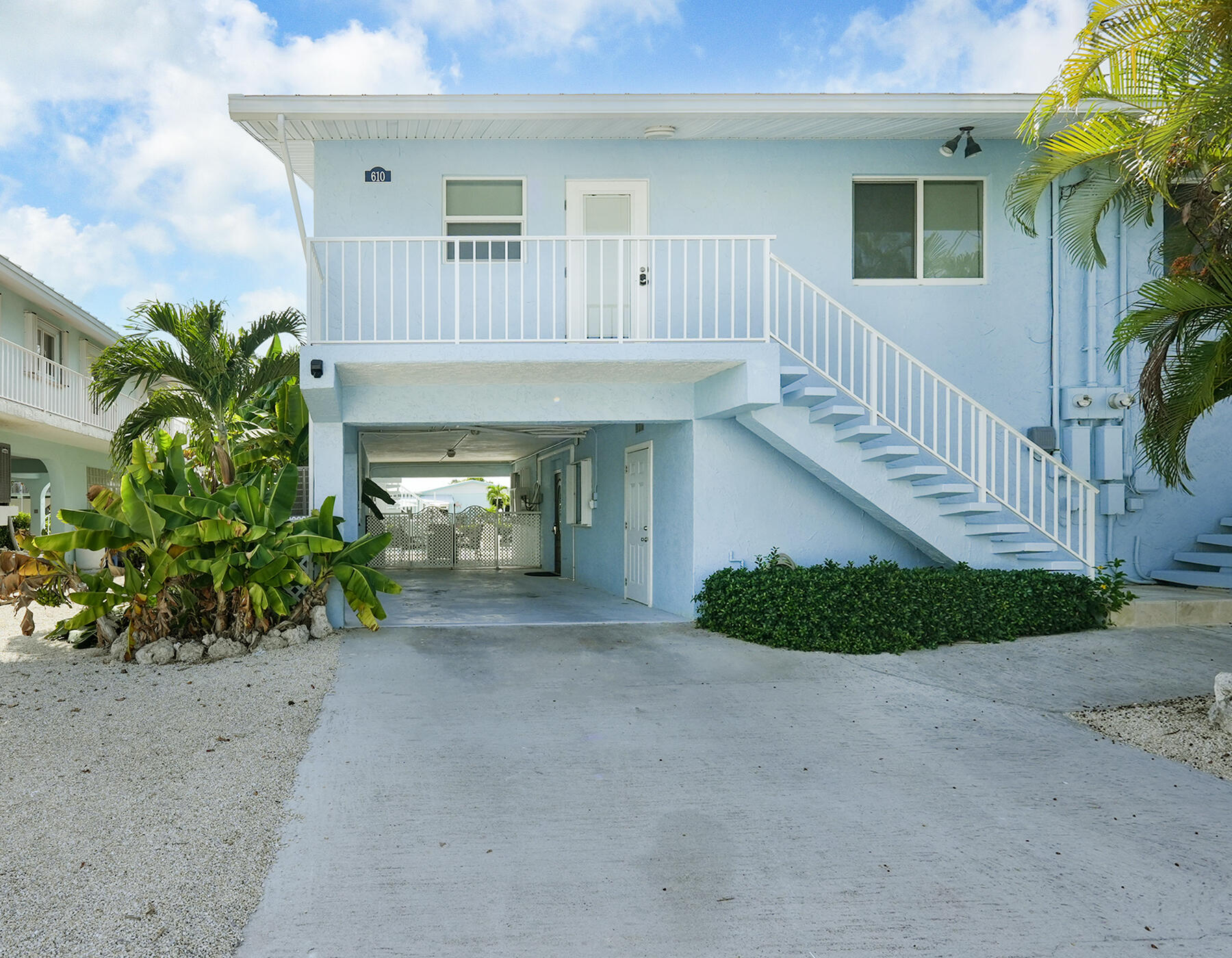 610 9th Street Key Colony Beach, FL 33051 - Photo 8 of 28 a view of a house with a small yard and flower plants