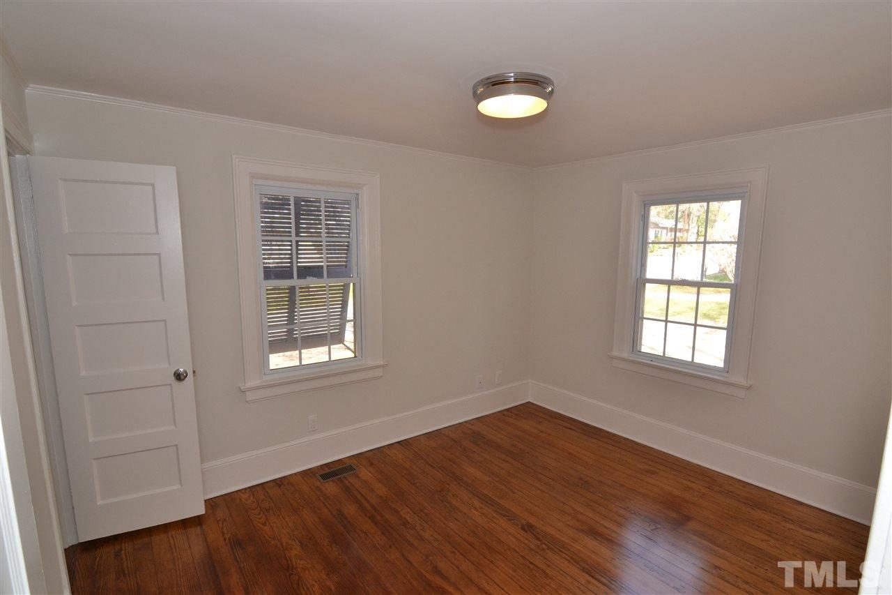 2403 Bedford Avenue Raleigh, NC 27607 - Photo 7 of 14 an empty room with wooden floor and windows