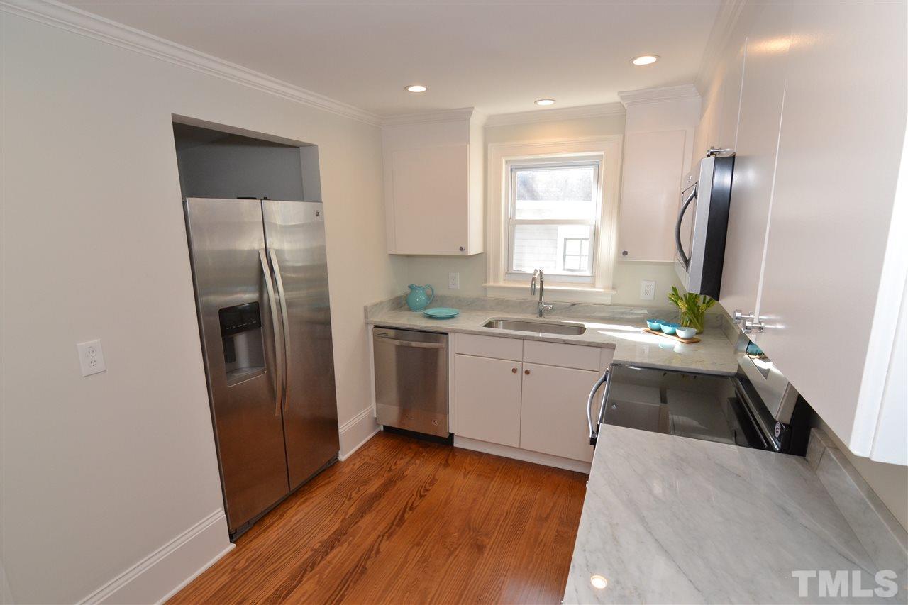 2403 Bedford Avenue Raleigh, NC 27607 - Photo 8 of 14 a kitchen with a refrigerator sink and cabinets