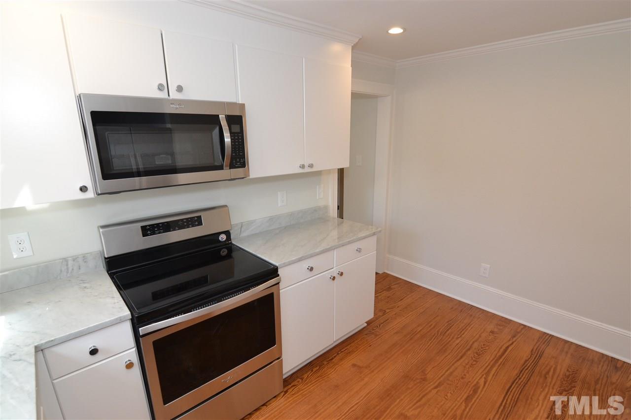 2403 Bedford Avenue Raleigh, NC 27607 - Photo 10 of 14 a kitchen with a stove and a microwave