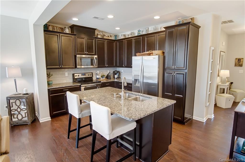 827 Ayrshire Avenue Fort Mill, SC 29708 - Photo 12 of 47 a kitchen with kitchen island a refrigerator stove microwave and cabinets