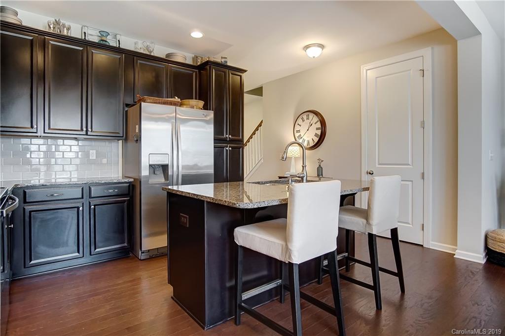 827 Ayrshire Avenue Fort Mill, SC 29708 - Photo 14 of 47 a kitchen with stainless steel appliances granite countertop a stove refrigerator and chairs