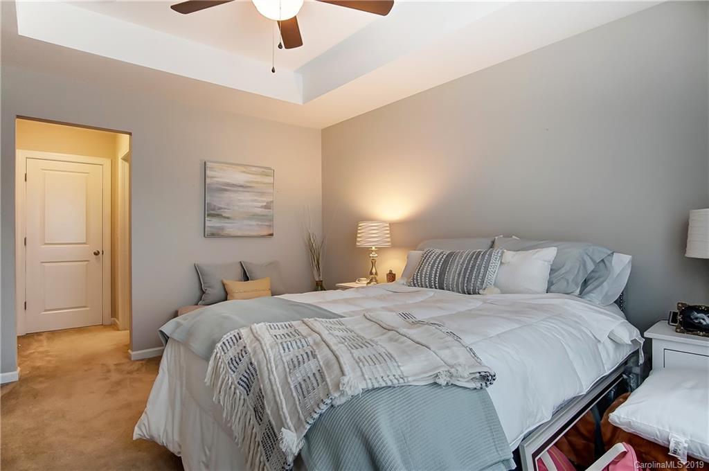 827 Ayrshire Avenue Fort Mill, SC 29708 - Photo 23 of 47 a bedroom with a bed and a chandelier