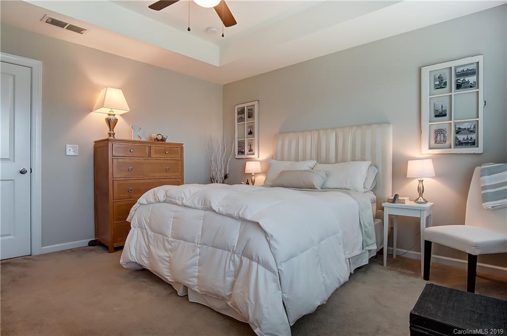 827 Ayrshire Avenue Fort Mill, SC 29708 - Photo 30 of 47 a bedroom with a bed and a chandelier