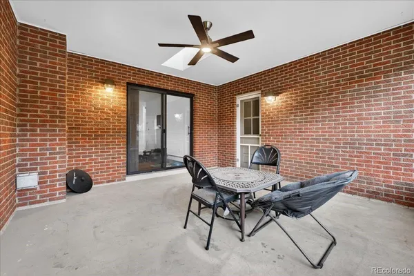 a view of a livingroom with furniture and a ceiling fan