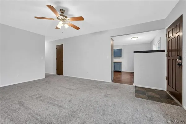 a view of an empty room with a ceiling fan