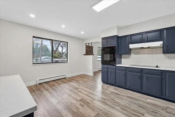 a room with wooden floors and wooden cabinets