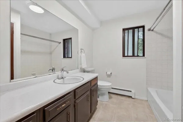 a bathroom with a sink a toilet and mirror