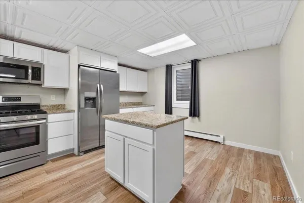 a kitchen with a stove a refrigerator and a sink