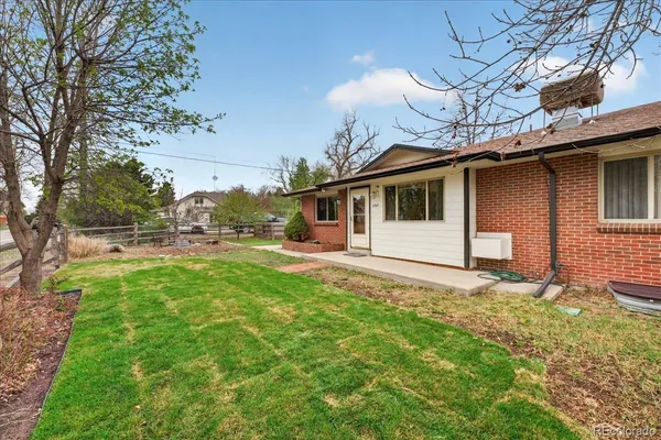 a backyard of a house with table and chairs