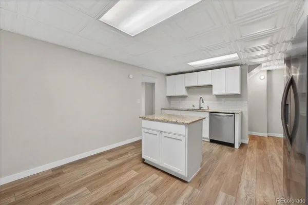 a kitchen with a white cabinets stove and refrigerator