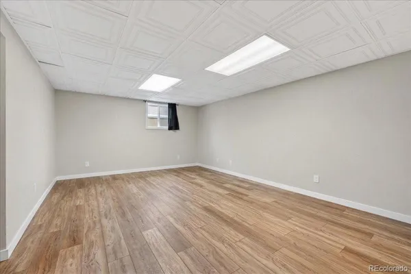 a view of an empty room and wooden floor