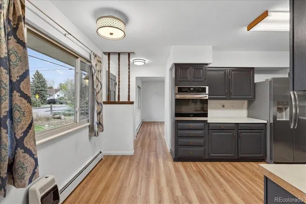 a kitchen with stainless steel appliances a refrigerator and a stove top oven