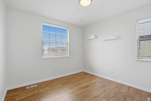2007 Fielding Hill Lane Draper, UT 84020 - Photo 27 of 83 Bright room featuring two windows with blinds, wood-finish flooring, white baseboards, and a flush-mount ceiling light