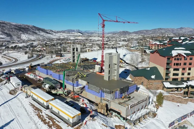 an aerial view of a house with a mountain