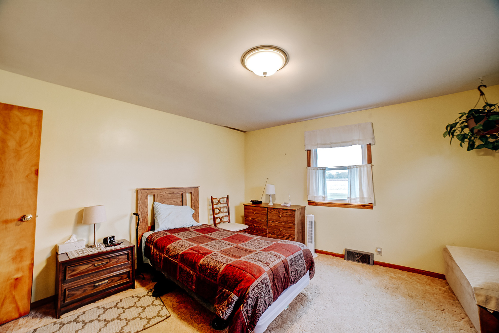 1505 North 2000 East Road Watseka, IL 60970 - Photo 26 of 39 a bedroom with a bed and wooden floor