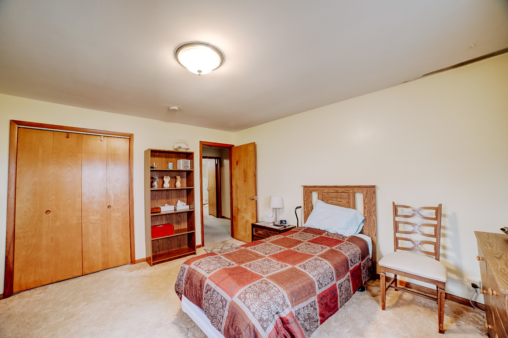 1505 North 2000 East Road Watseka, IL 60970 - Photo 27 of 39 a bedroom with a bed and a bookshelf