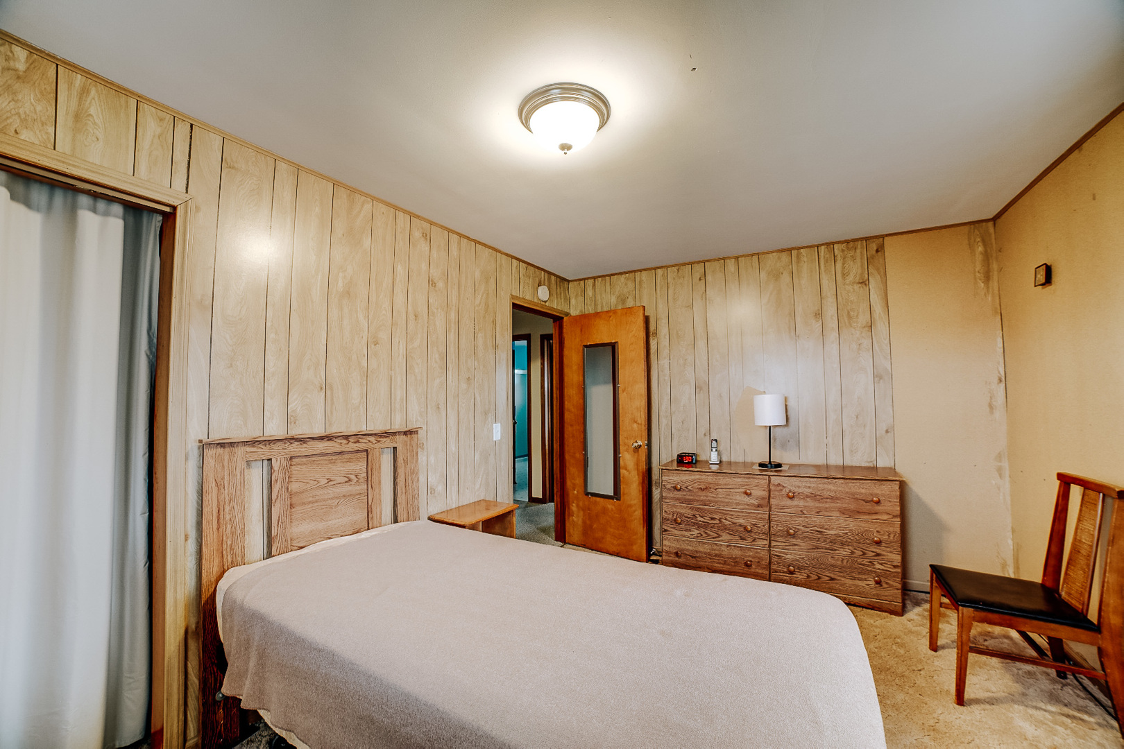 1505 North 2000 East Road Watseka, IL 60970 - Photo 34 of 39 a bedroom with a bed and a dresser with mirror