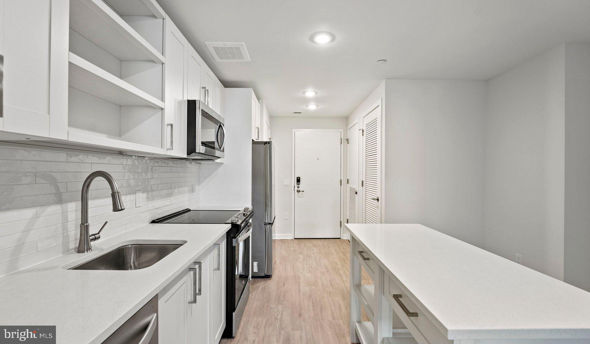 3990 Upton Street Northwest, Unit 2BPARCT110 Washington, DC 20016 - Photo 33 of 49 a kitchen with a sink and a refrigerator