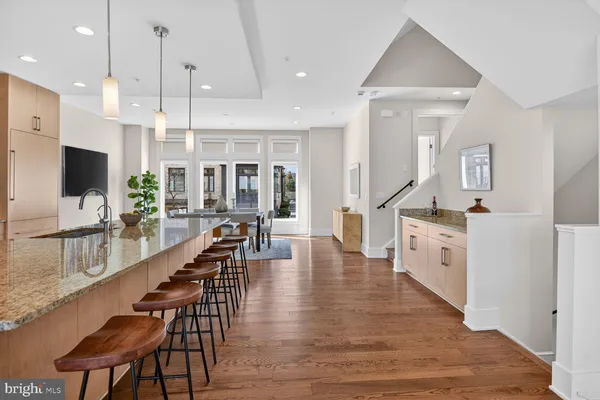 a large kitchen with white cabinets and stainless steel appliances
