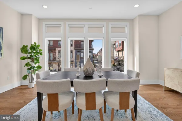 a dining room with furniture and wooden floor