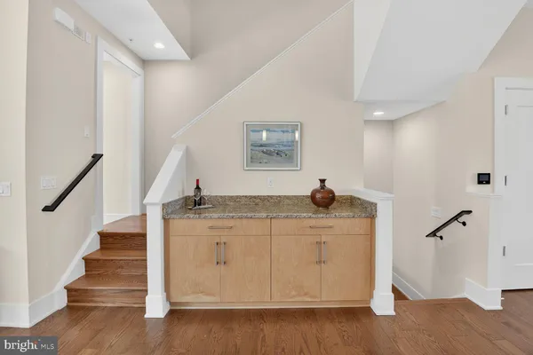 a view of entryway and hall with wooden floor