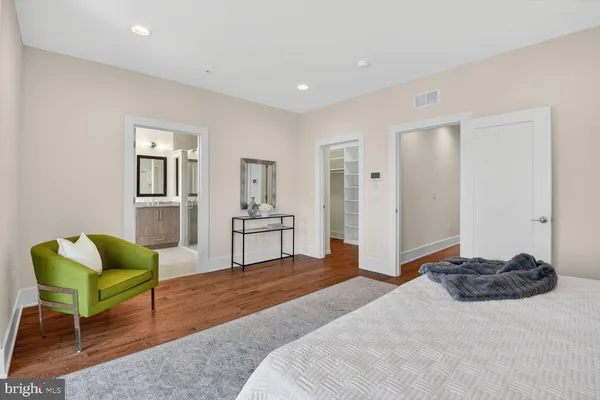 a bedroom with a bed window and chair