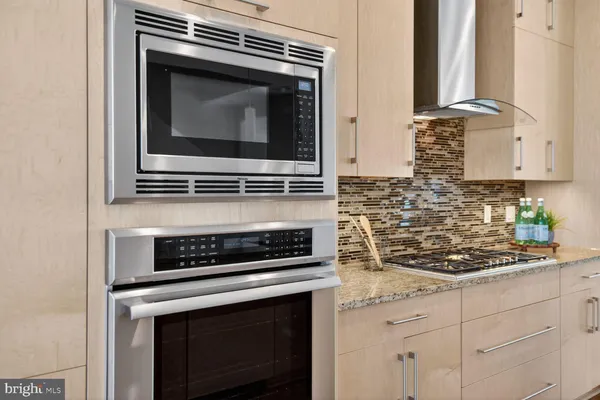 a kitchen with microwave stove and cabinets