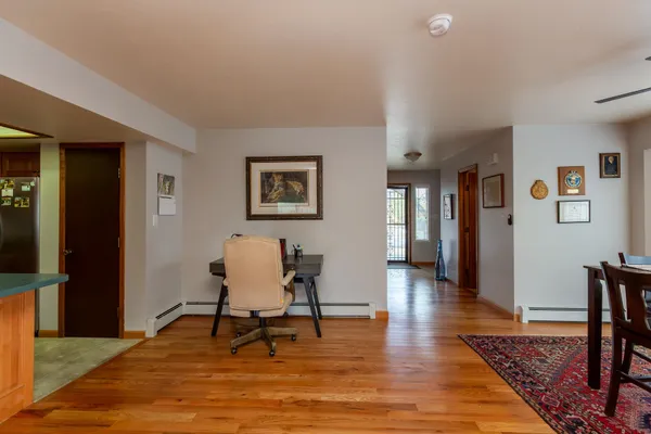 a living room with furniture rug and a table