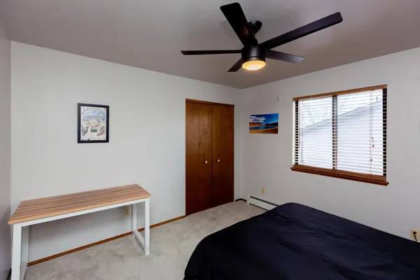 a bedroom with a bed and a window