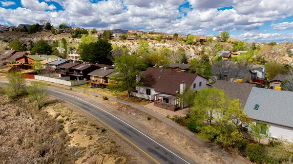 an aerial view of a residential houses with city view