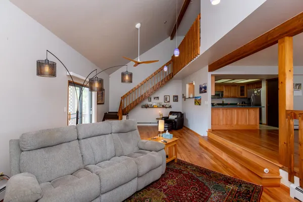 a living room with furniture and wooden floor