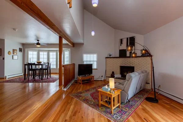 a living room with furniture a fireplace and a flat screen tv