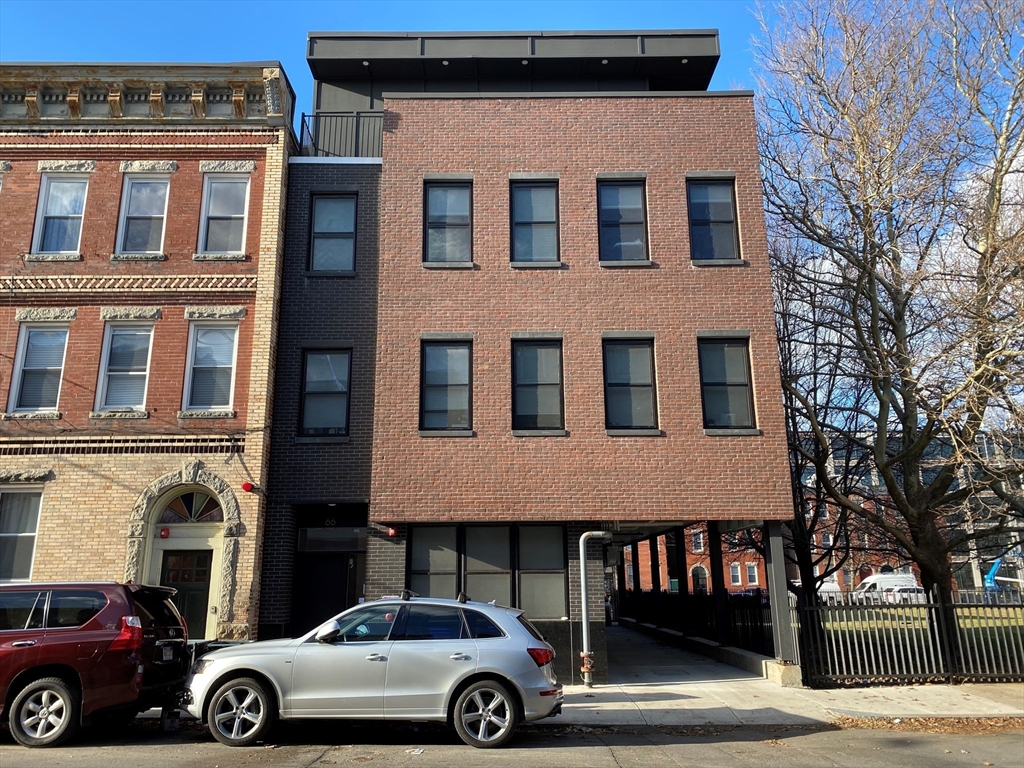 a view of a car parked in front of a building