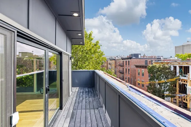 a view of a balcony with wooden floor