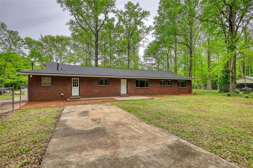 555 Joy Street Jackson, GA 30233 - Photo 6 of 56 front view of a house with a yard