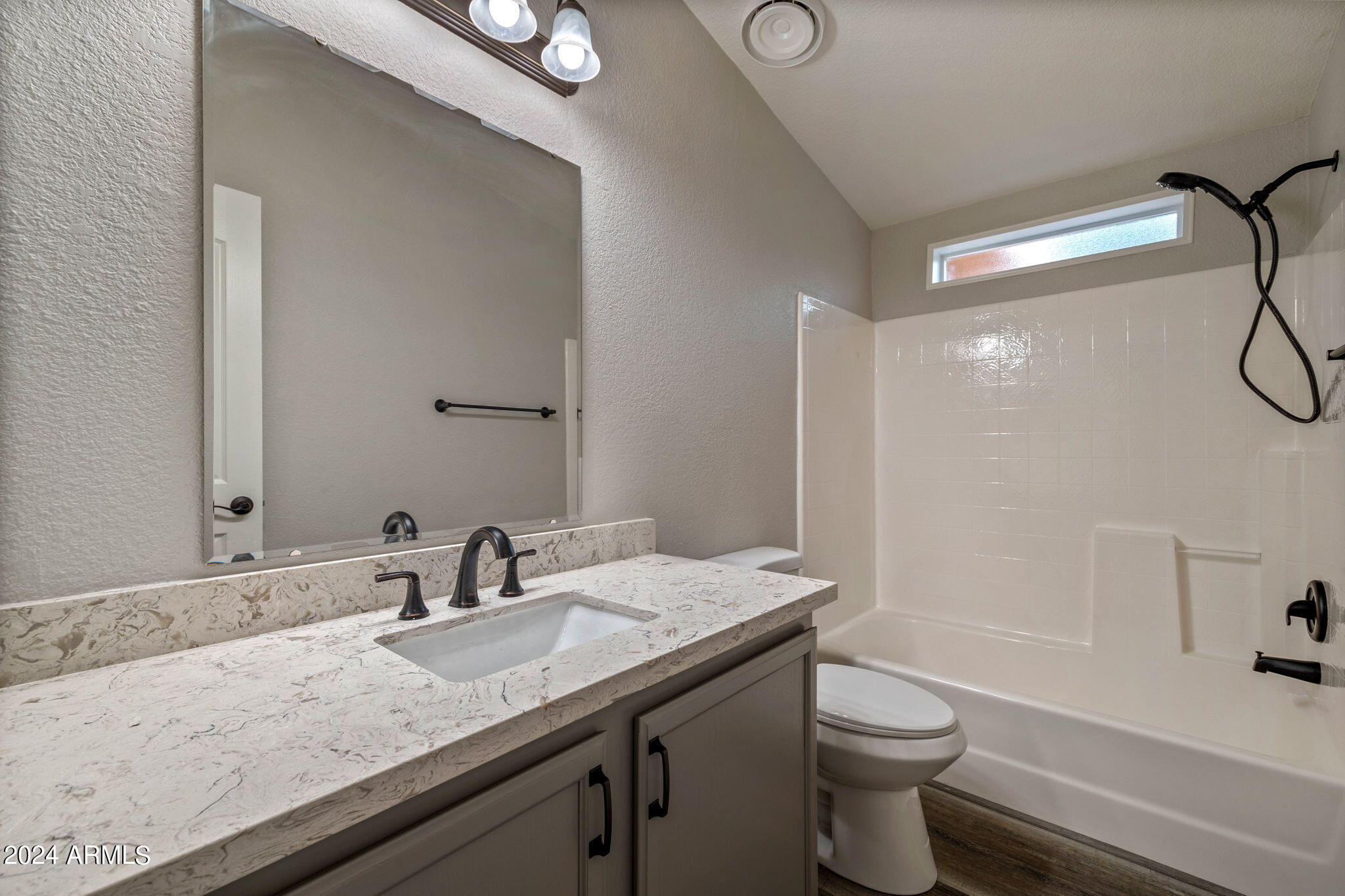 2192 Gingerbread Trail Overgaard, AZ 85933 - Photo 29 of 48 a bathroom with a granite countertop sink a toilet and shower