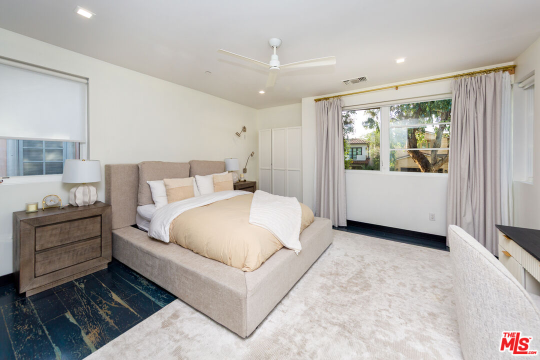 9401 Kirkside Road Los Angeles, CA 90035 - Photo 11 of 18 a large white bed sitting in a room next to a window