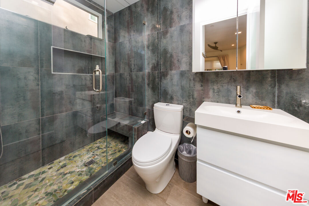9401 Kirkside Road Los Angeles, CA 90035 - Photo 13 of 18 a bathroom with a sink toilet and shower