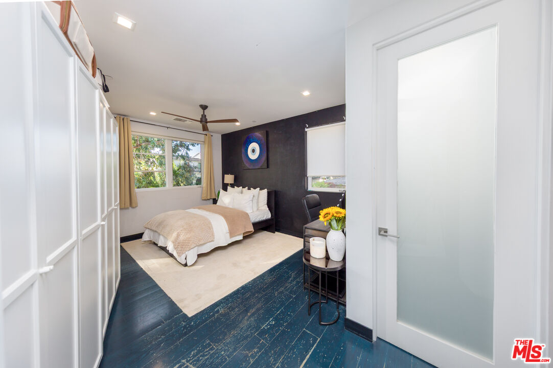 9401 Kirkside Road Los Angeles, CA 90035 - Photo 14 of 18 a bedroom with a bed and wooden floor