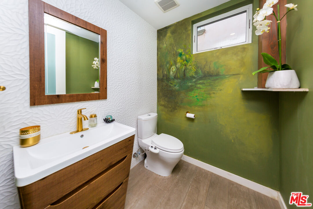 9401 Kirkside Road Los Angeles, CA 90035 - Photo 15 of 18 a bathroom with a sink mirror and toilet