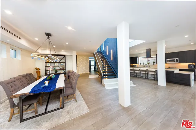 a living room with furniture and kitchen view