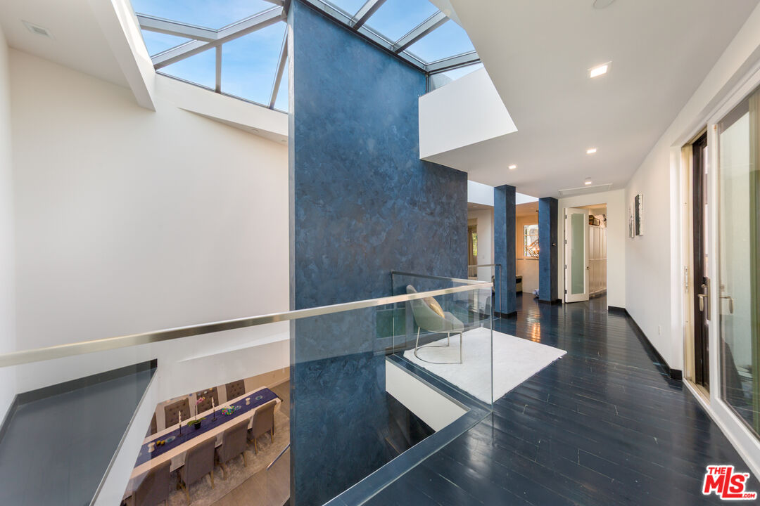 9401 Kirkside Road Los Angeles, CA 90035 - Photo 6 of 18 a hallway with furniture and wooden floor